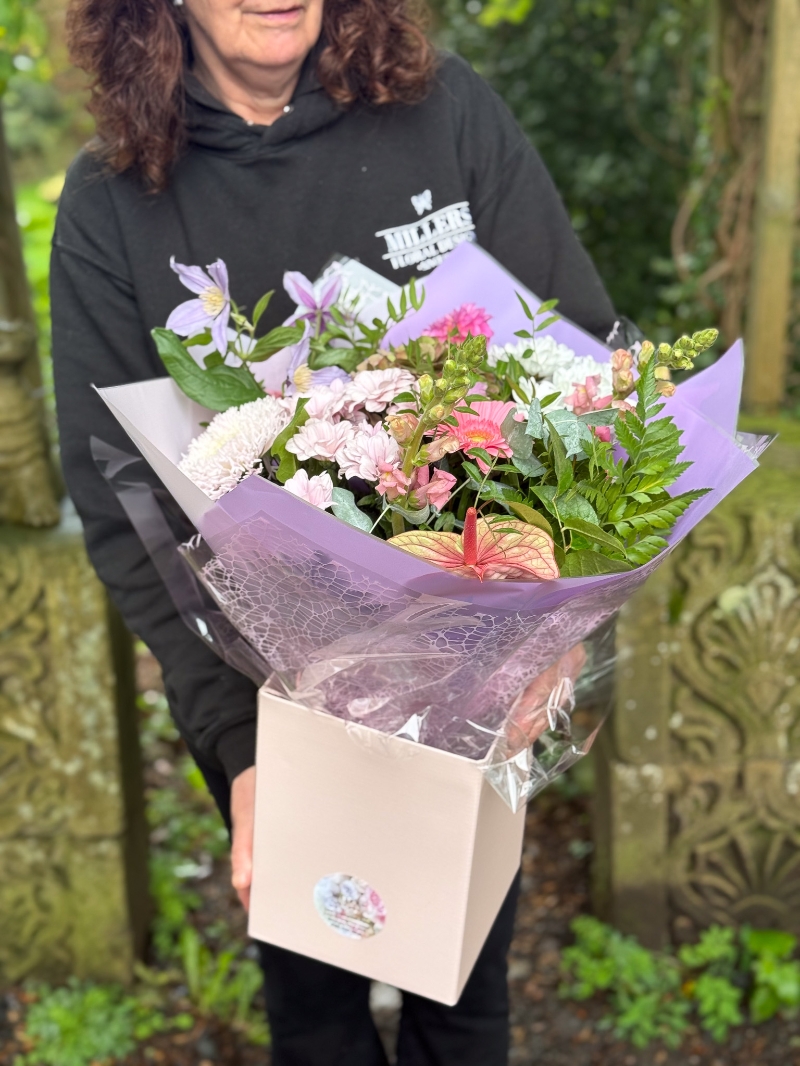 Blush and lilac hand-tied bouquet with pink anthurium, hydrangea, germini, chrysanthemums and seasonal foliage