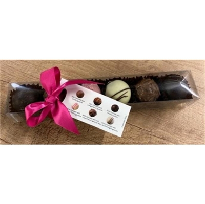 Gift box of six assorted milk, dark and white chocolate truffles presented in clear packaging with a pink ribbon at Millers Floral Design.