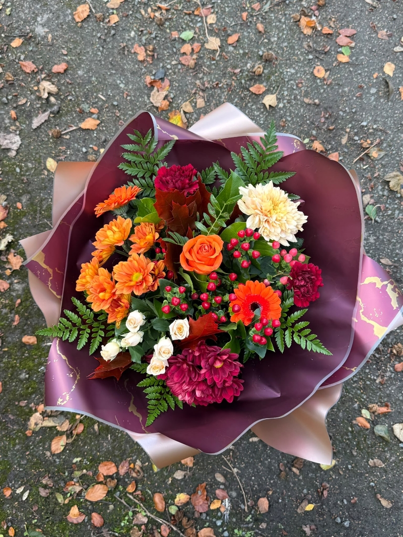 October autumn bouquet by Millers Floral Design featuring orange roses, chrysanthemums, cream spray roses and red berries.
