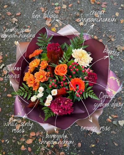 October autumn bouquet by Millers Floral Design featuring orange roses, chrysanthemums, cream spray roses and red berries.