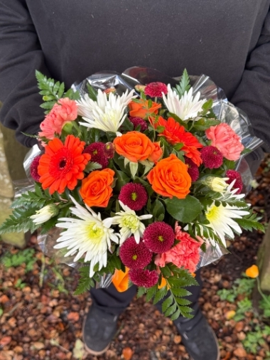 Autumn Glow orange and burgundy hatbox flower arrangement by Millers Floral Design in Royton