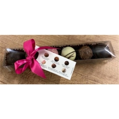 Gift box of six assorted milk, dark and white chocolate truffles presented in clear packaging with a pink ribbon at Millers Floral Design.