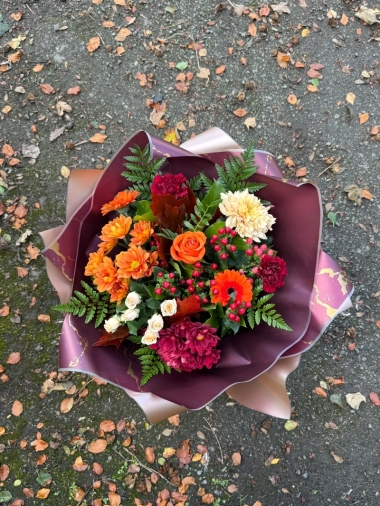 October autumn bouquet by Millers Floral Design featuring orange roses, chrysanthemums, cream spray roses and red berries.